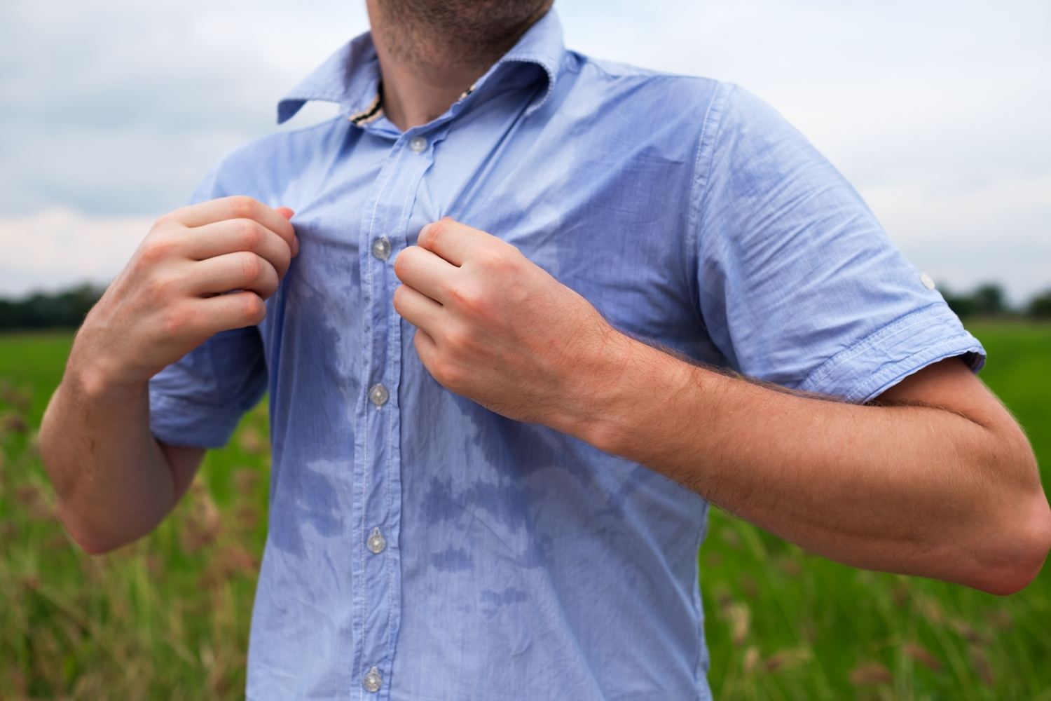 Man in Tennessee sweating excessively in the humidity because of hyperhidrosis symptoms