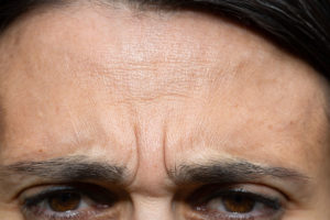A close up image of a womans face focused on her eyebrows and the 