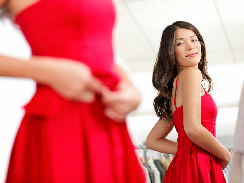 A beautiful woman in a red dress after diep flap surgery